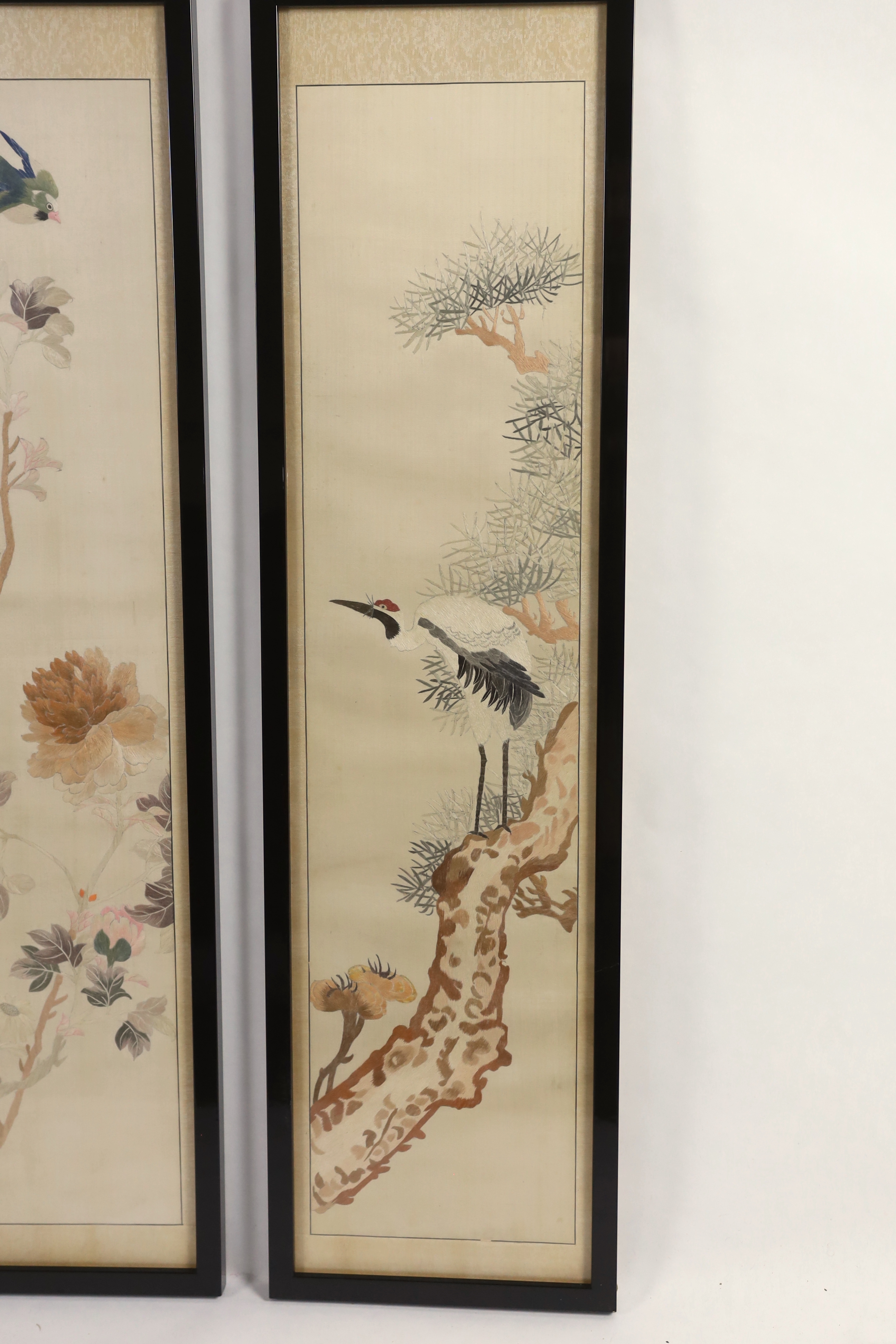 A set of four framed Chinese silk embroideries, of “The Four Seasons”, late Qing dynasty, embroidered with birds and trees and flowers, 96cm high x 22cm wide